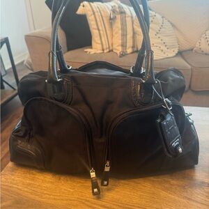 Tumi Black Travel Bag with Textured Material and Gold Zippers